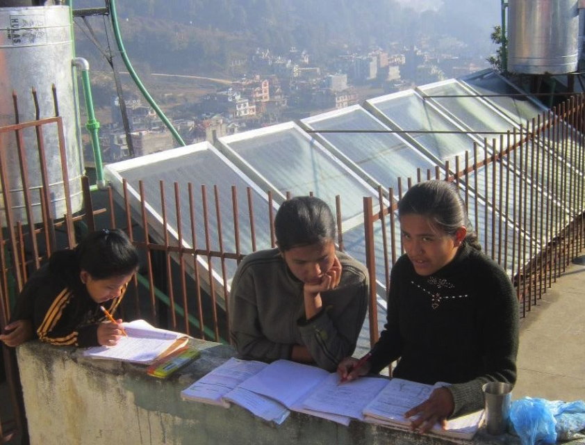 Some of the older girls studying on the roof in front of the solar hot water array. Even with so many panels, the kids are on a hot shower schedule by grade. A cold shower can be had anytime.
